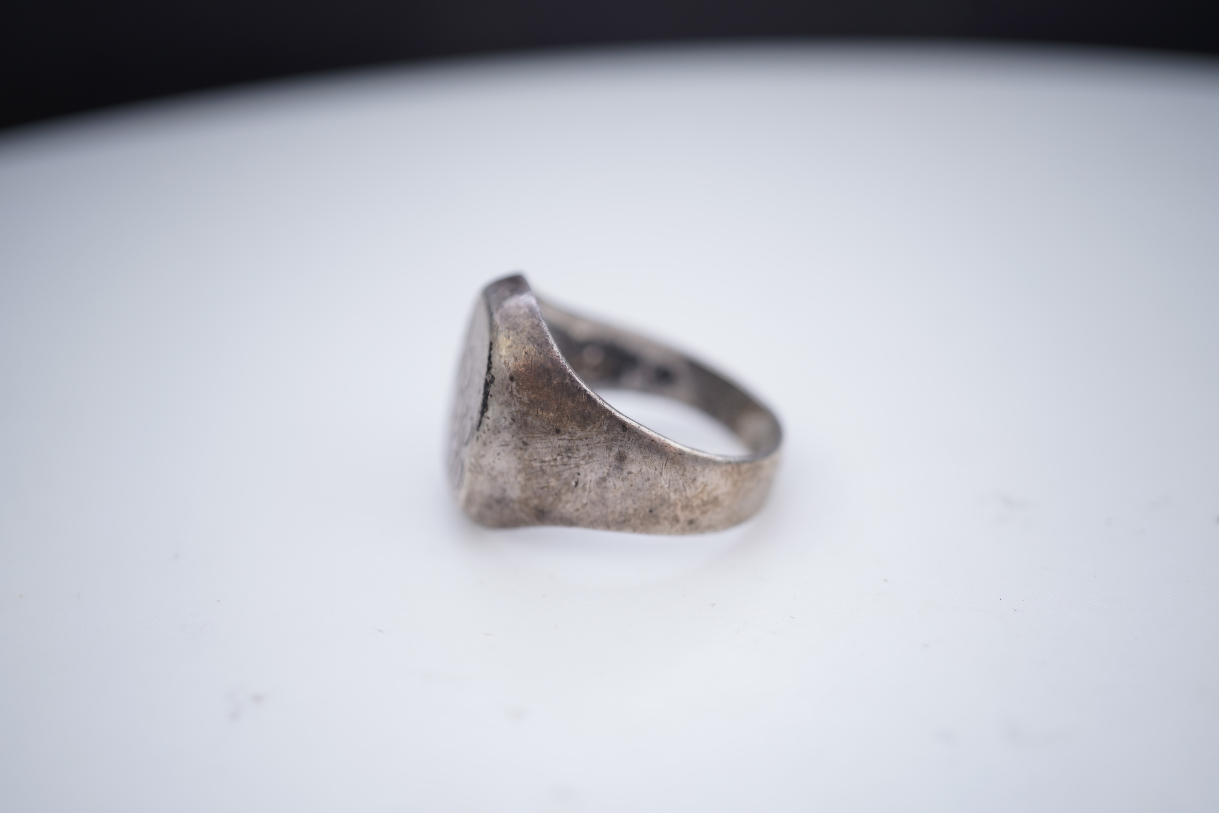 A collection of silver jewels, comprising: a bangle; a chain necklace suspending two winding toothpicks, one with toothpick deficient; a rope twist chain; a pair of cufflinks with the initials DBH; a pendant of abstract